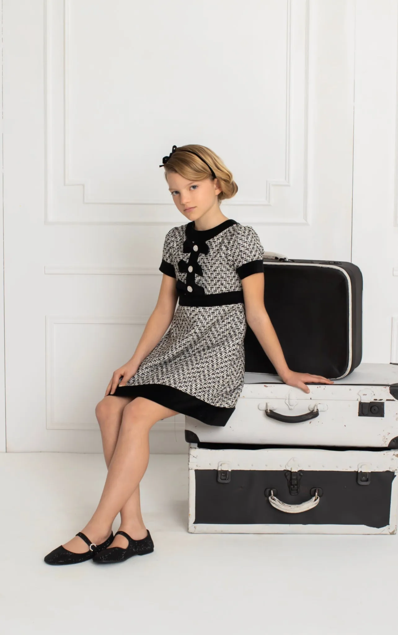 Beautiful girls Black and Ivory Tweed Dress with Bow details.